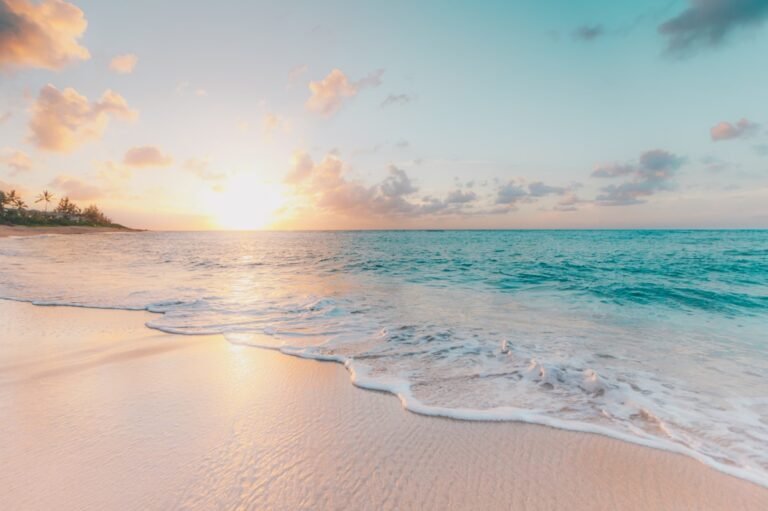 Quiet tropical beach and turquoise water at sunrise