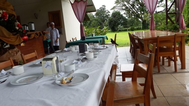 Open-air dining area at an eco-lodge surrounded by tropical vegetation in Costa Rica